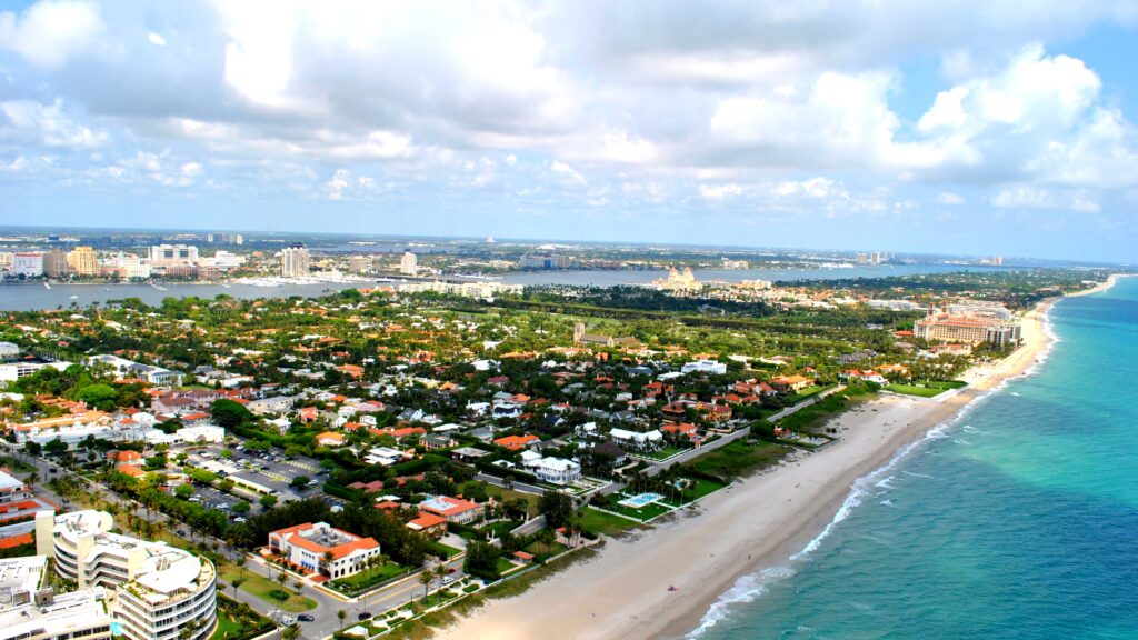 West Palm Beach waterfront with yachts docked and city skyline in the background.