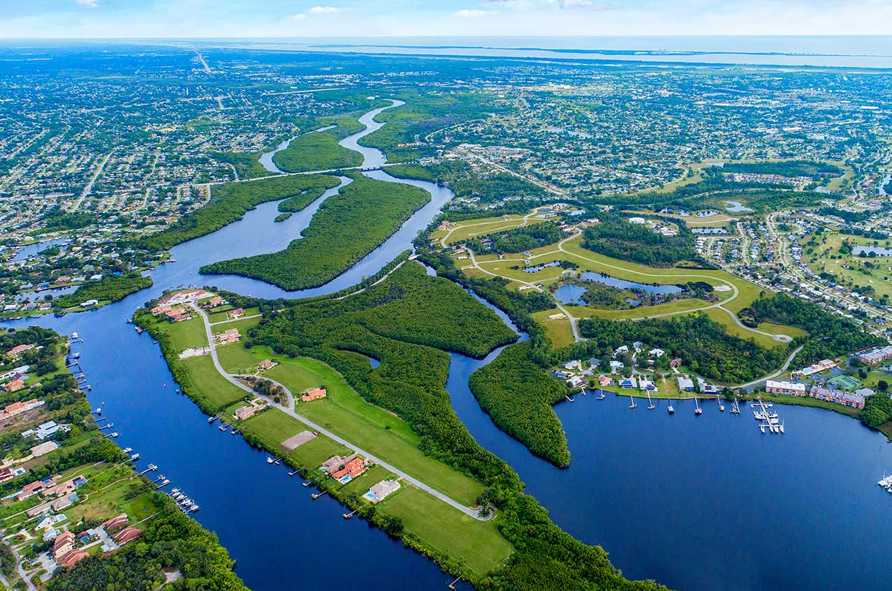 Scenic view of the St. Lucie River with boats and lush greenery in Port St. Lucie.